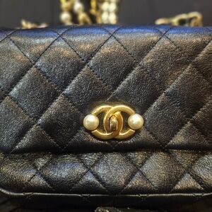 CHANEL Black Quilted Clutch with Gold Accents